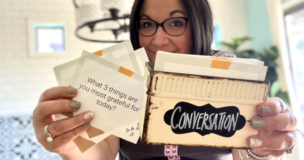 woman holding conversation cards