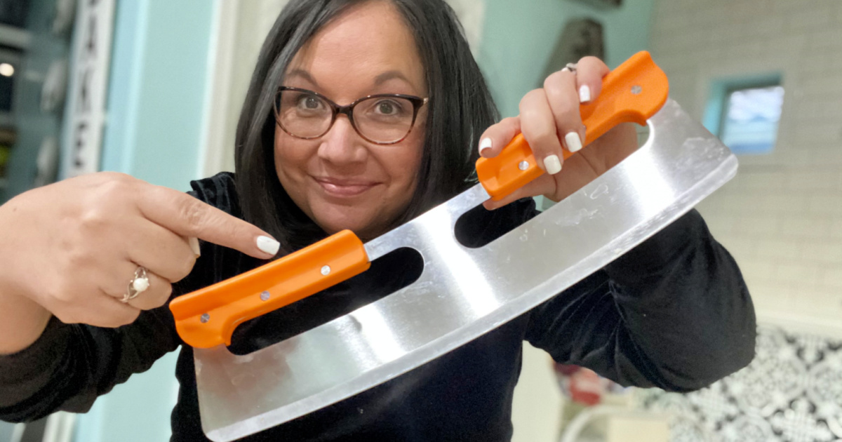 woman holding pizza cutter