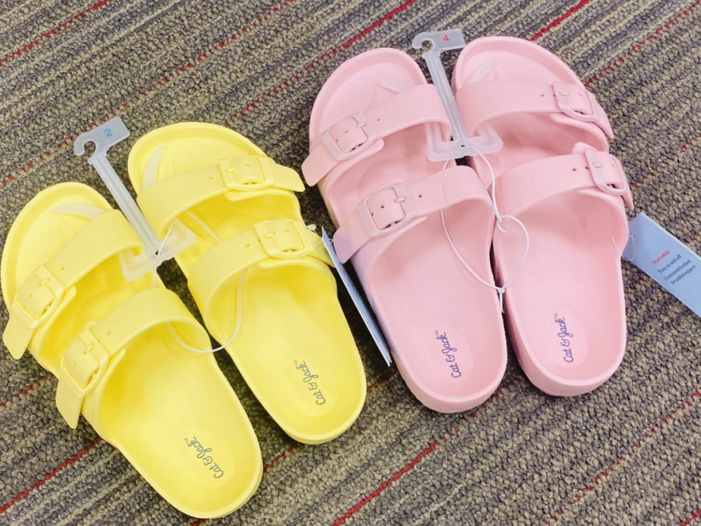 Two pairs of kids sandals on store floor