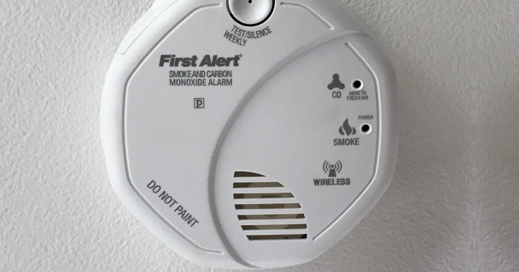 white smoke detector on wall