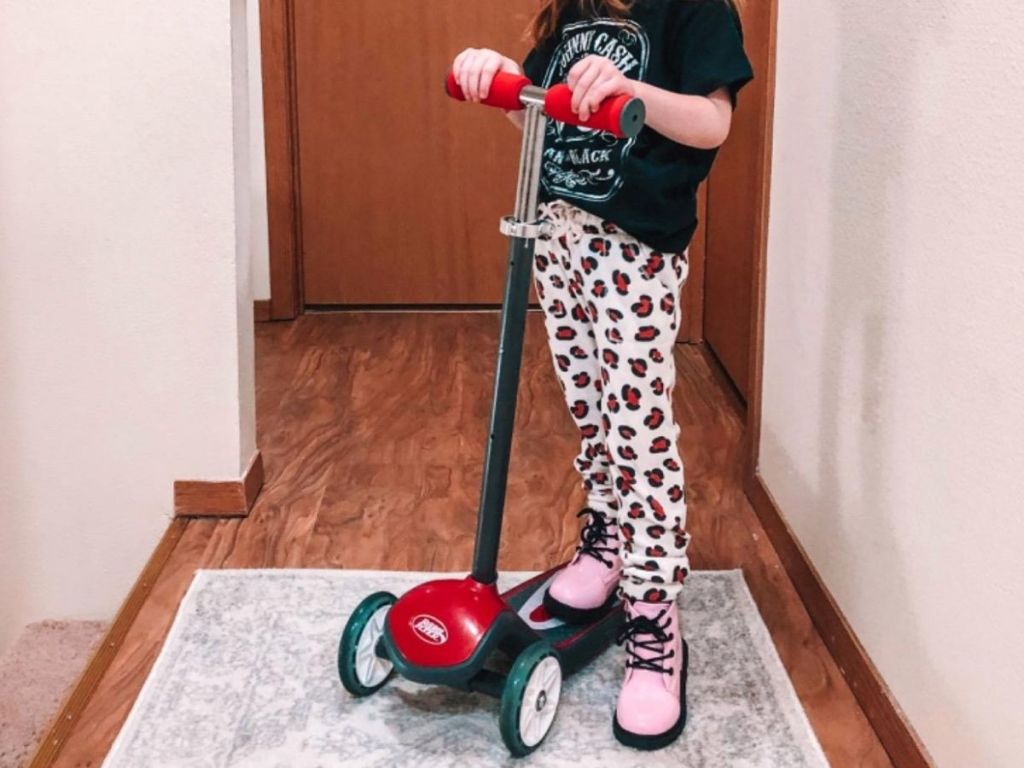 Little girl with radio flyer 3-wheel scooter