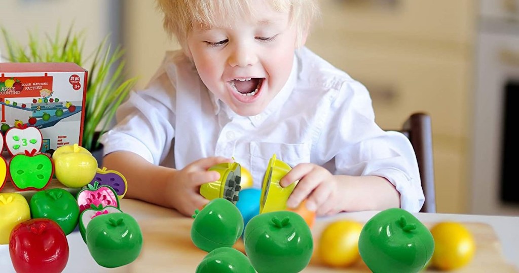 boy playing with toy apples