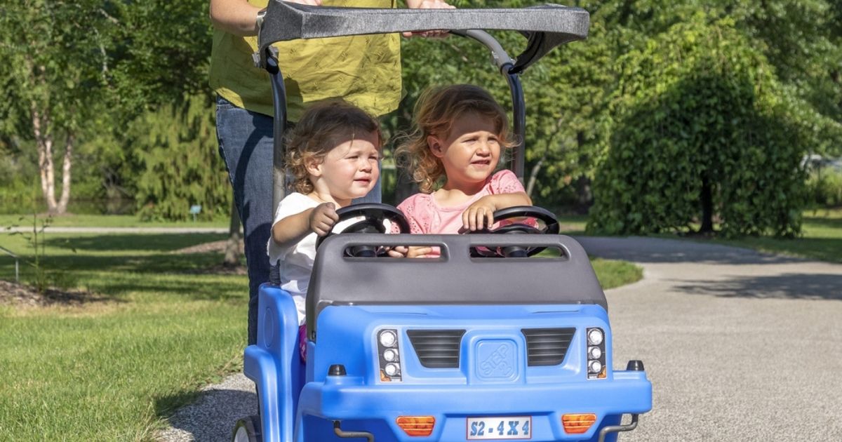 2 kids in a Step2 2-Seat SUV with lady pushing