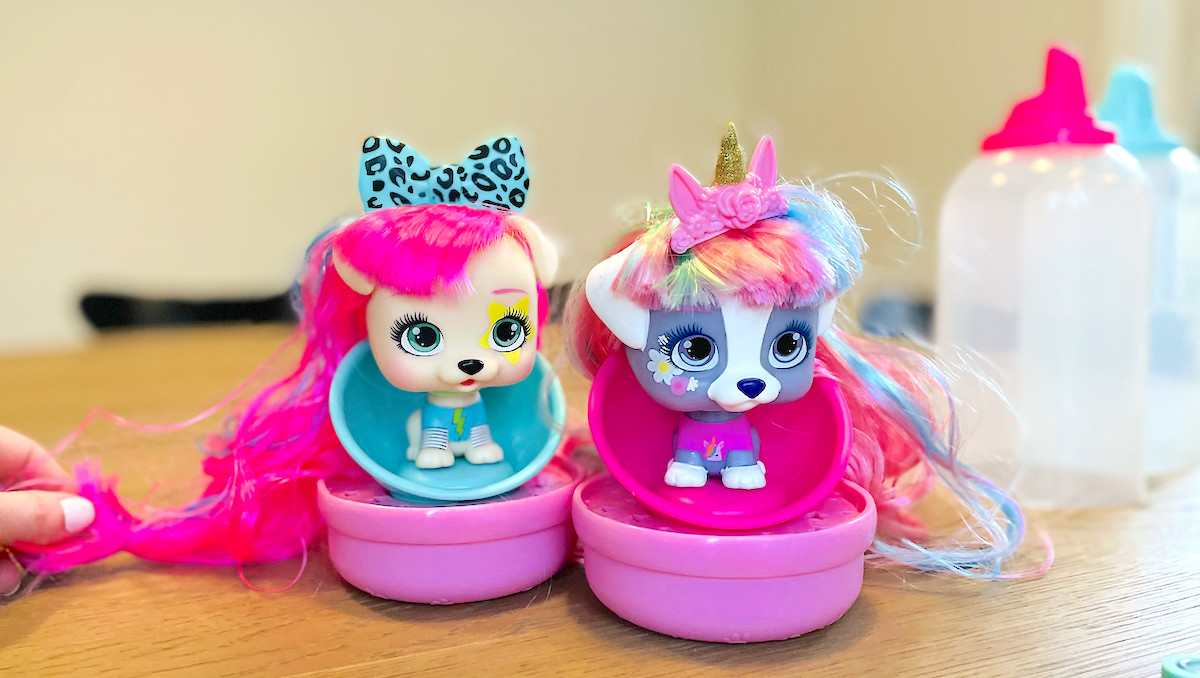 two VIP pet dolls sitting on table