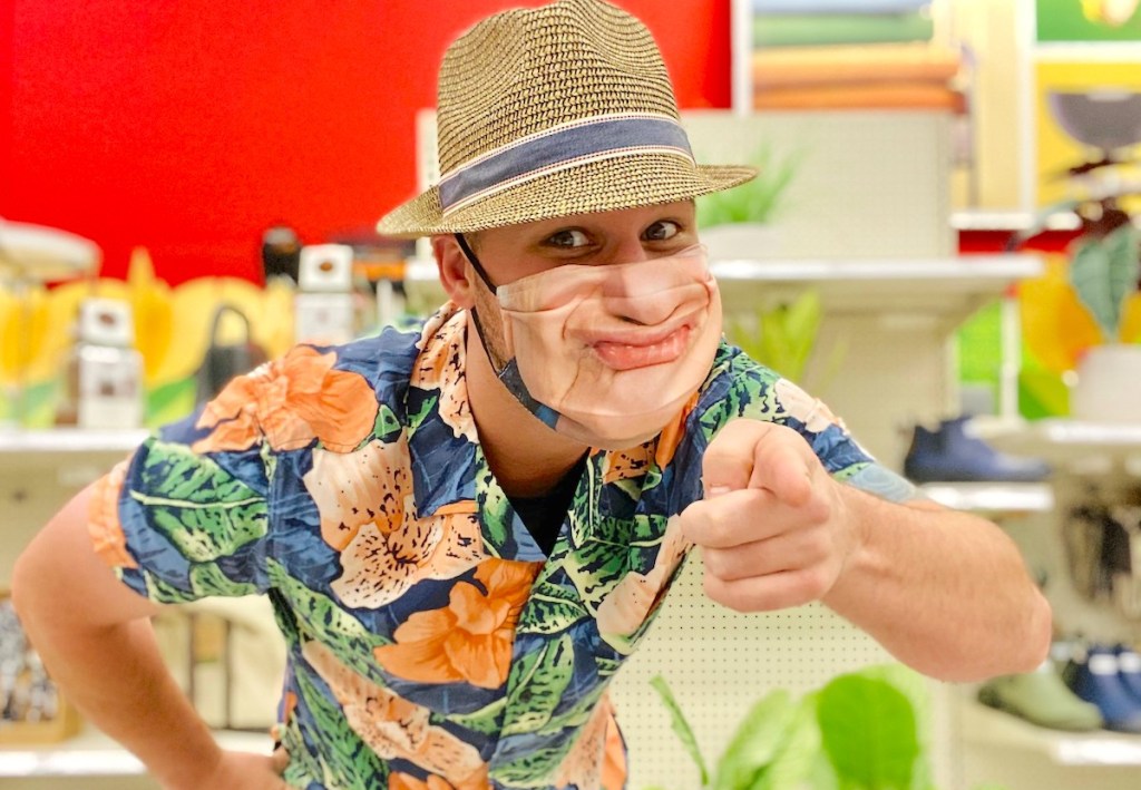 man wearing hat and novelty face mask in store