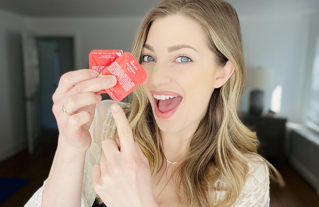 woman holding two packets of chick fil a bbq sauce april fools prank