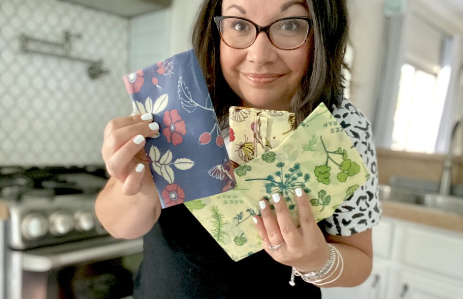 woman holding various styles of bees wraps