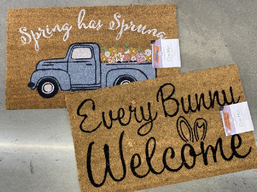 2 door mats on store floor with Spring theme