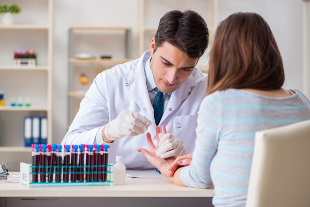 finger being pricked for blood before plasma donation