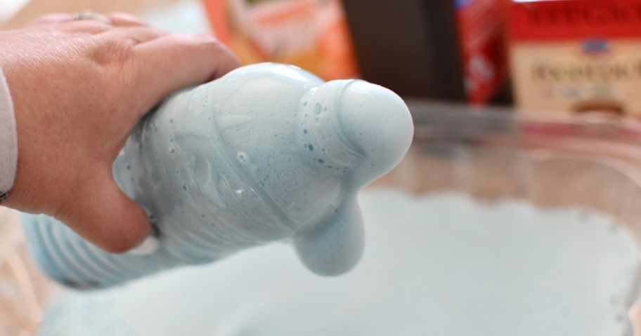 holding a bottle of elephants toothpaste