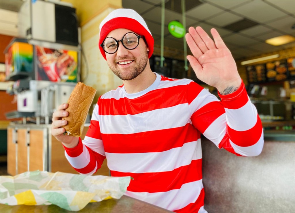 man eating a subway sandwich