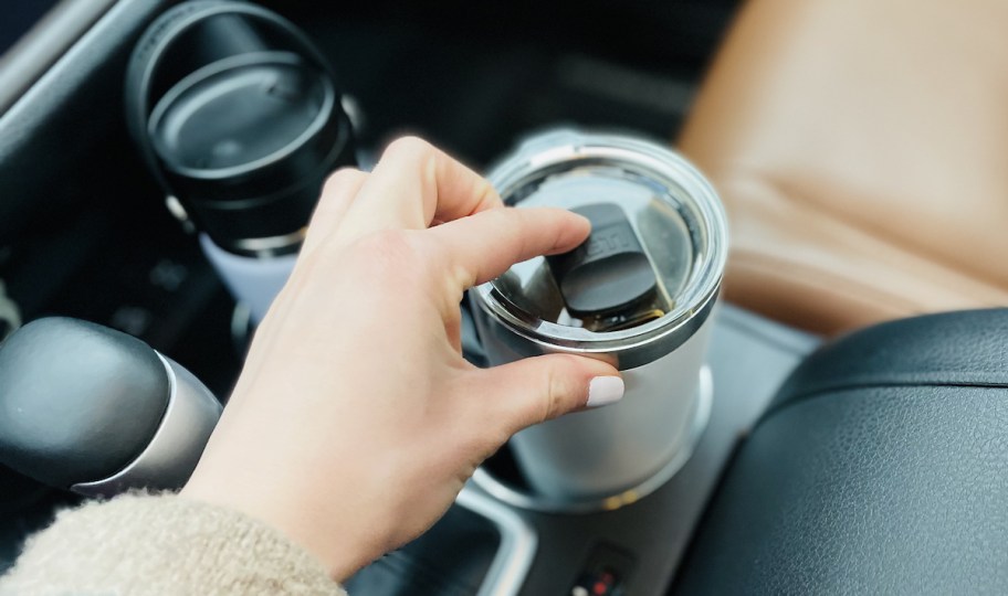 hand pushing on lid of yeti travel coffee mug