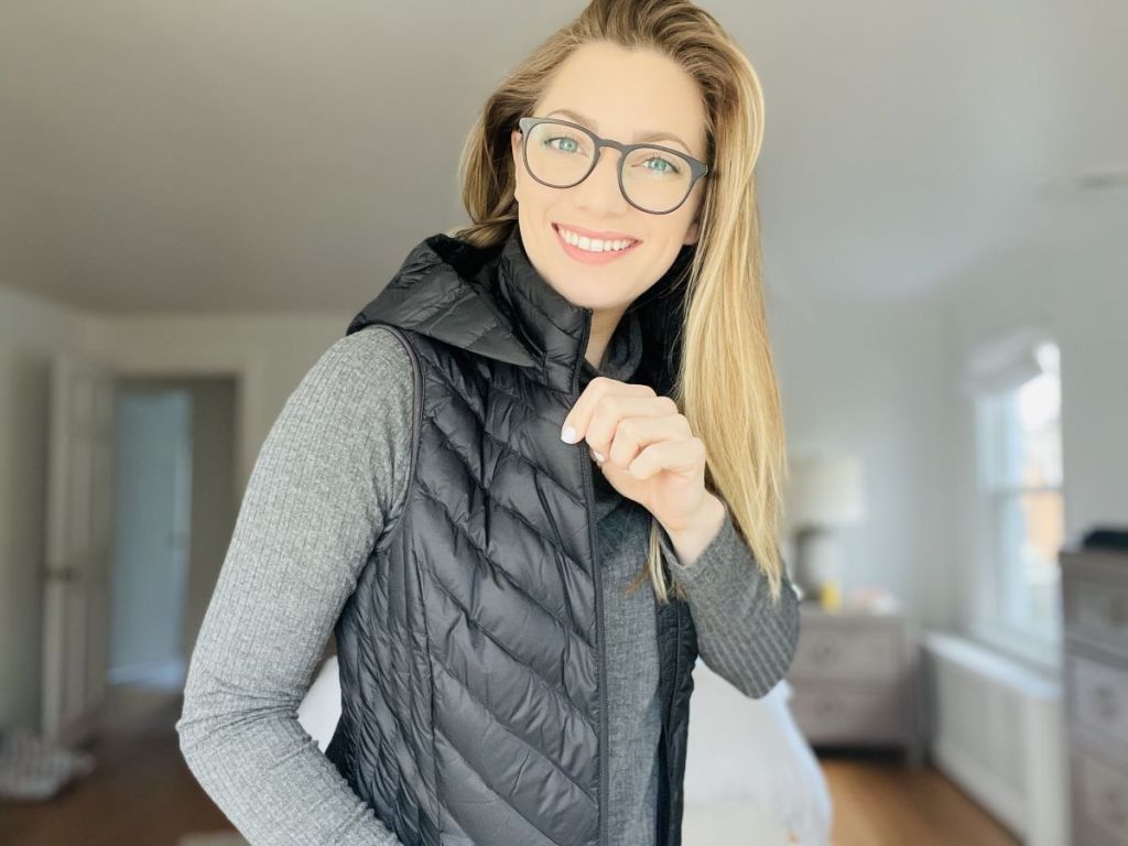 woman wearing a vest and smiling at the camera