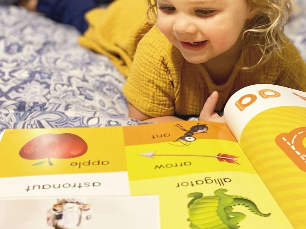 little girl reading book