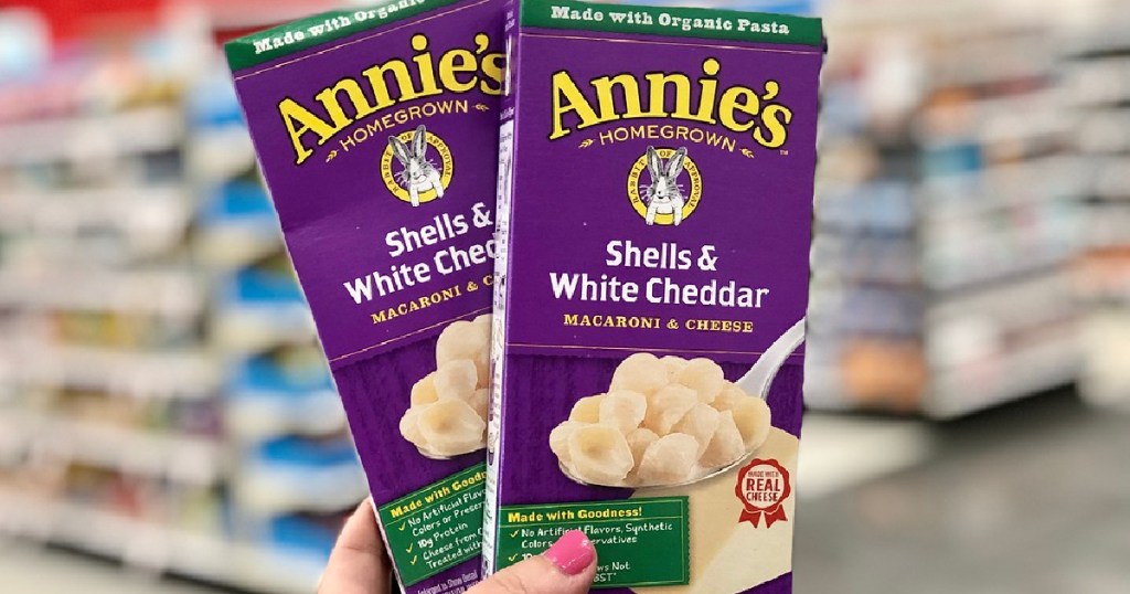 lady holding two boxes of Annie's macaroni & cheese