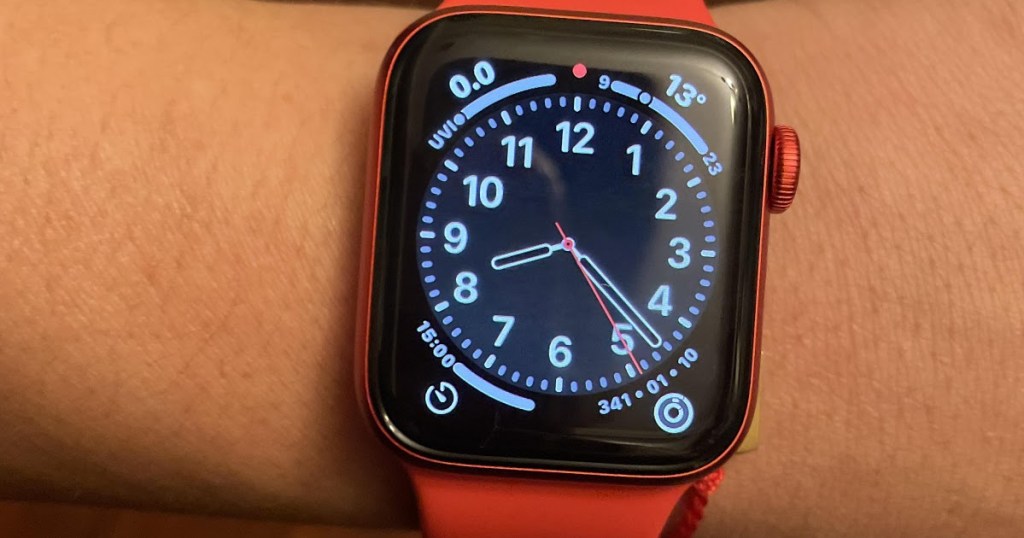 red smart watch on person's wrist