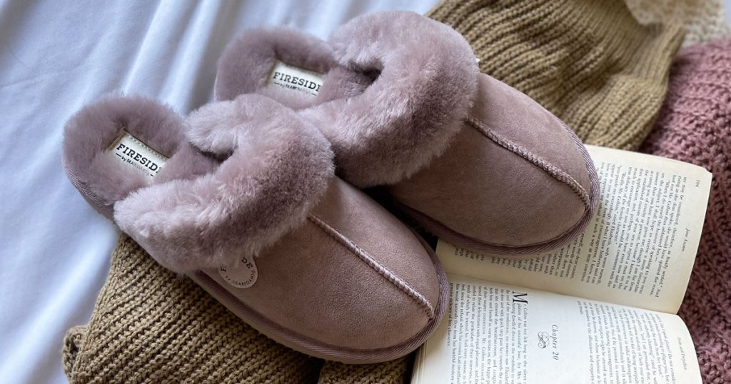 dusty rose colored pair of slippers on top of a book