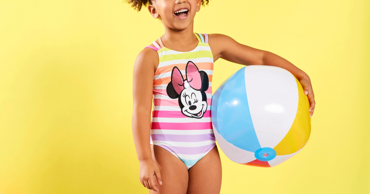 young girl holding a beachball