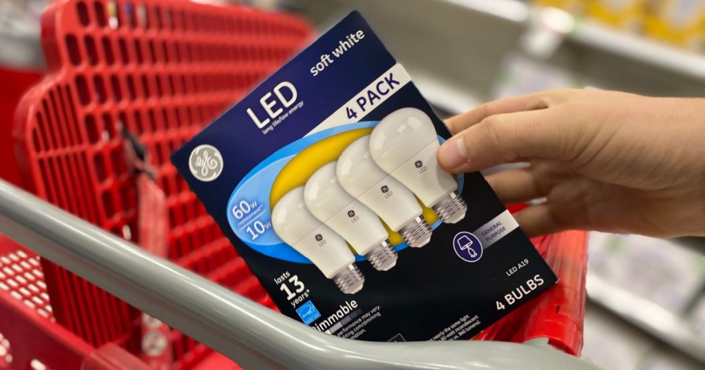 hand holding pack of lightbulbs 