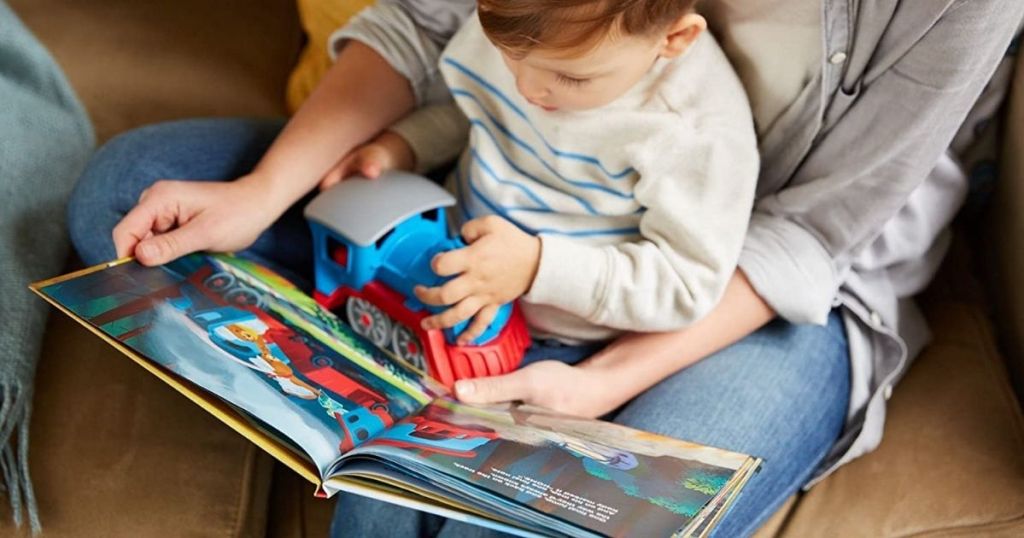 boy holding a toy train