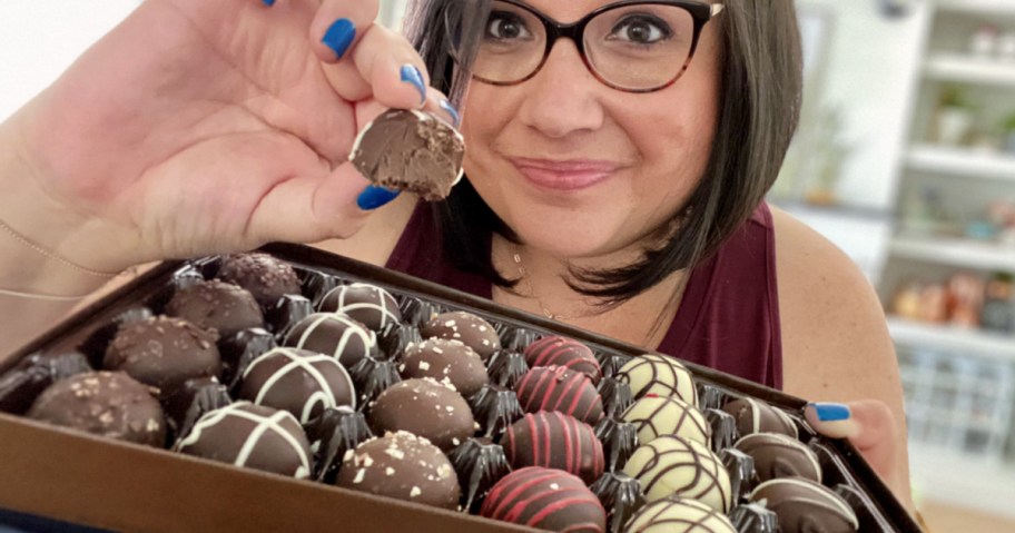 woman holding a box of harry & david chocolate truffles