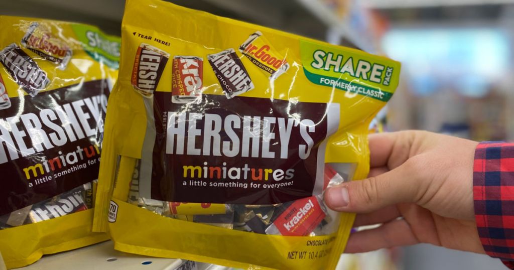 hand holding a yellow of candy