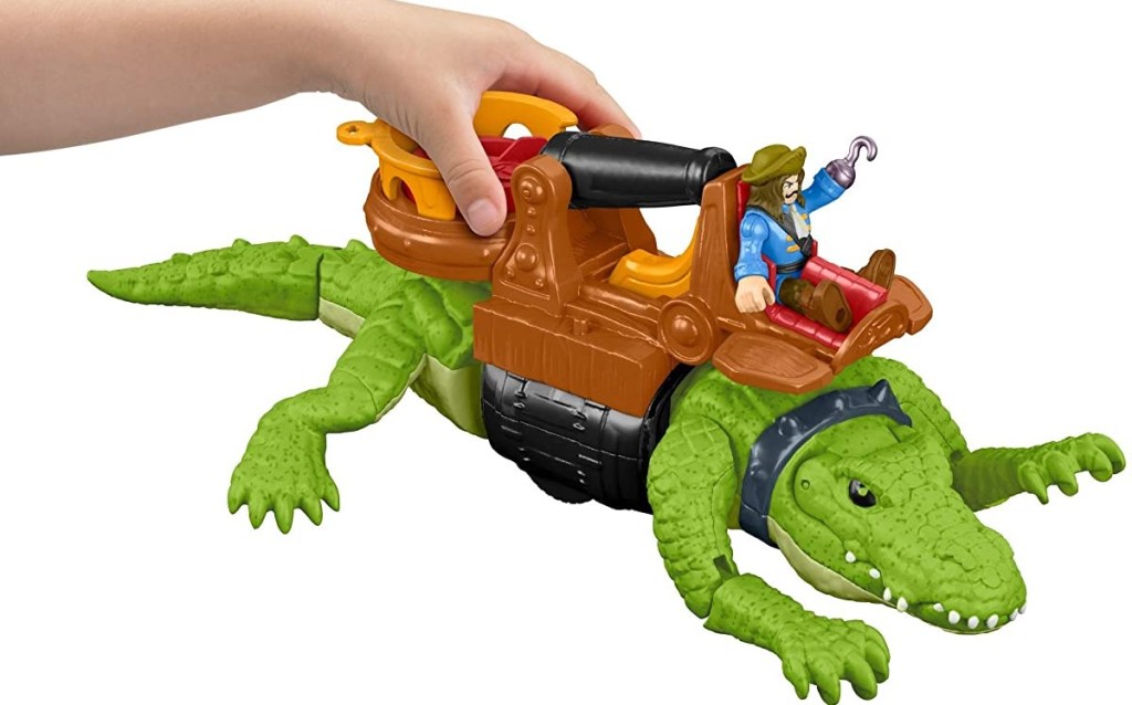 hand holding a toy crocodile