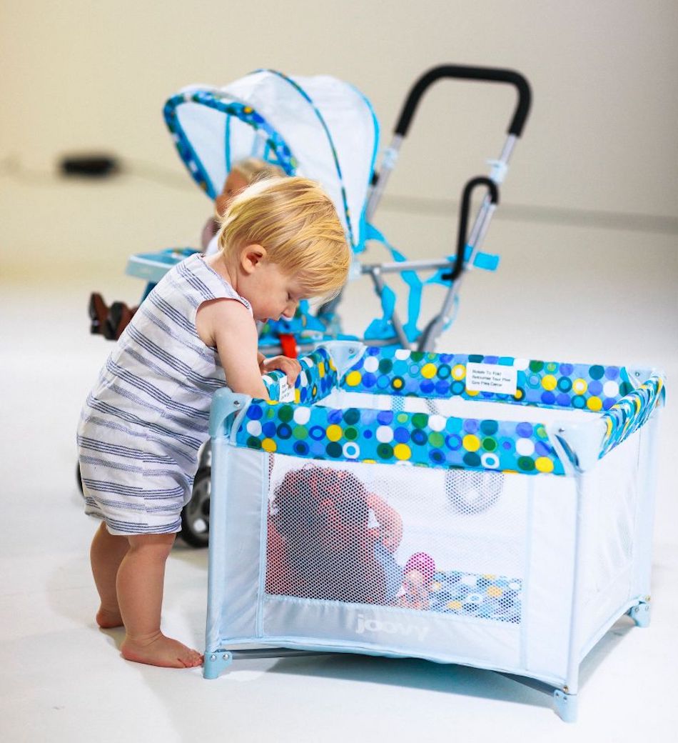 boy playing with Joovy Toy Playard in Blue