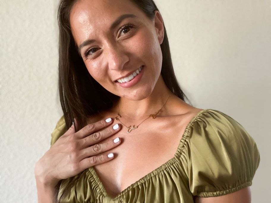 woman wearing a necklace with names on it