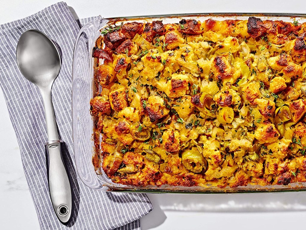 baking dish filled with food and serving spoon