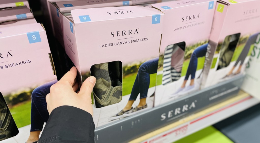 Hand grabbing a box of women's shoes