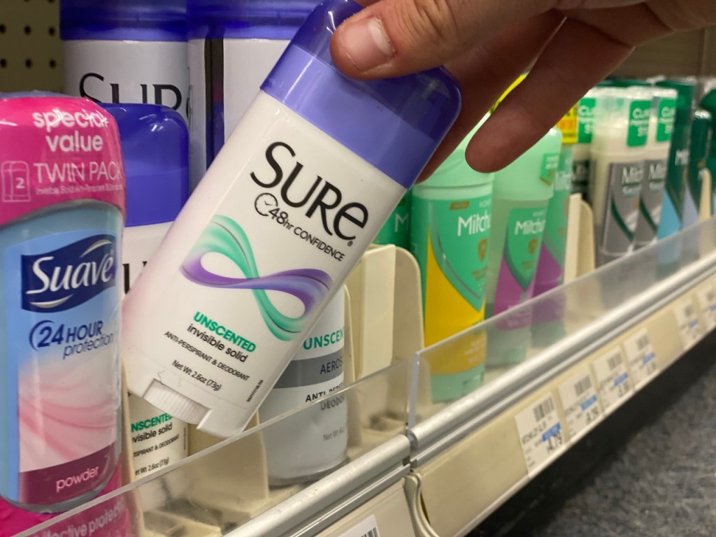 man pulling Sure Deodorant off shelf