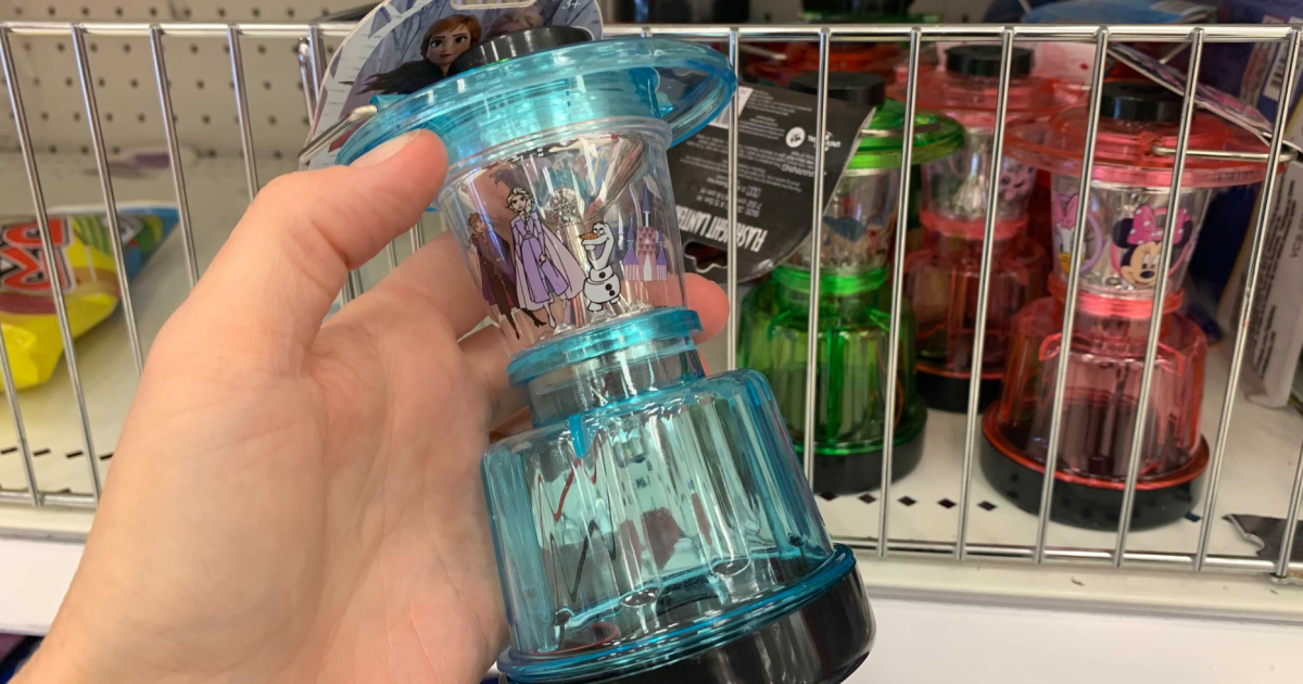 hand holding a blue kids flashlight lantern in front of a store display