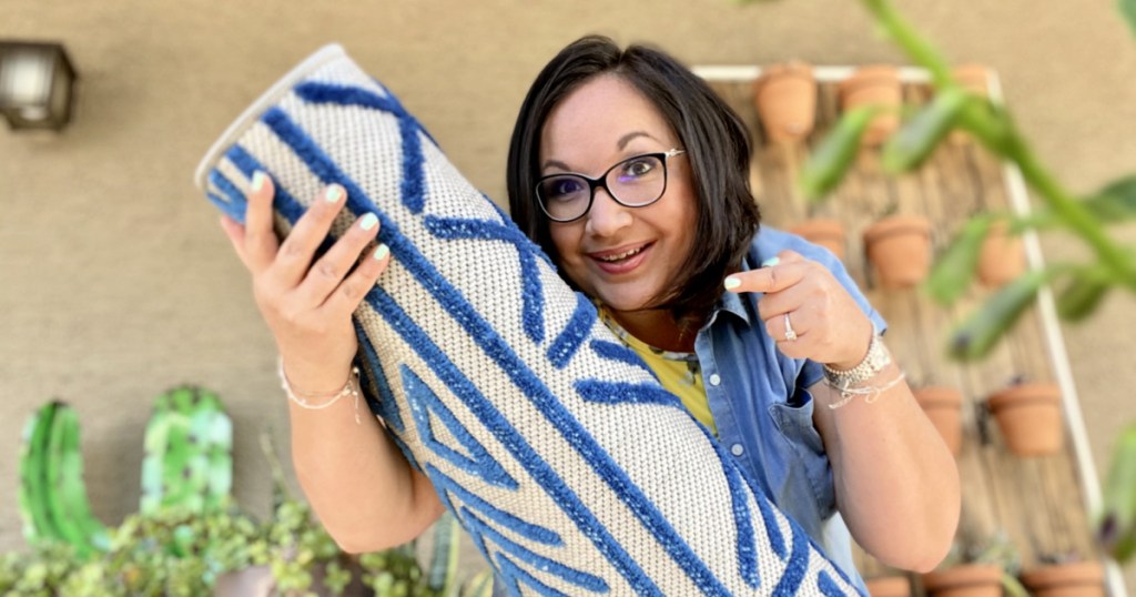 woman holding area rug from boutique rugs 