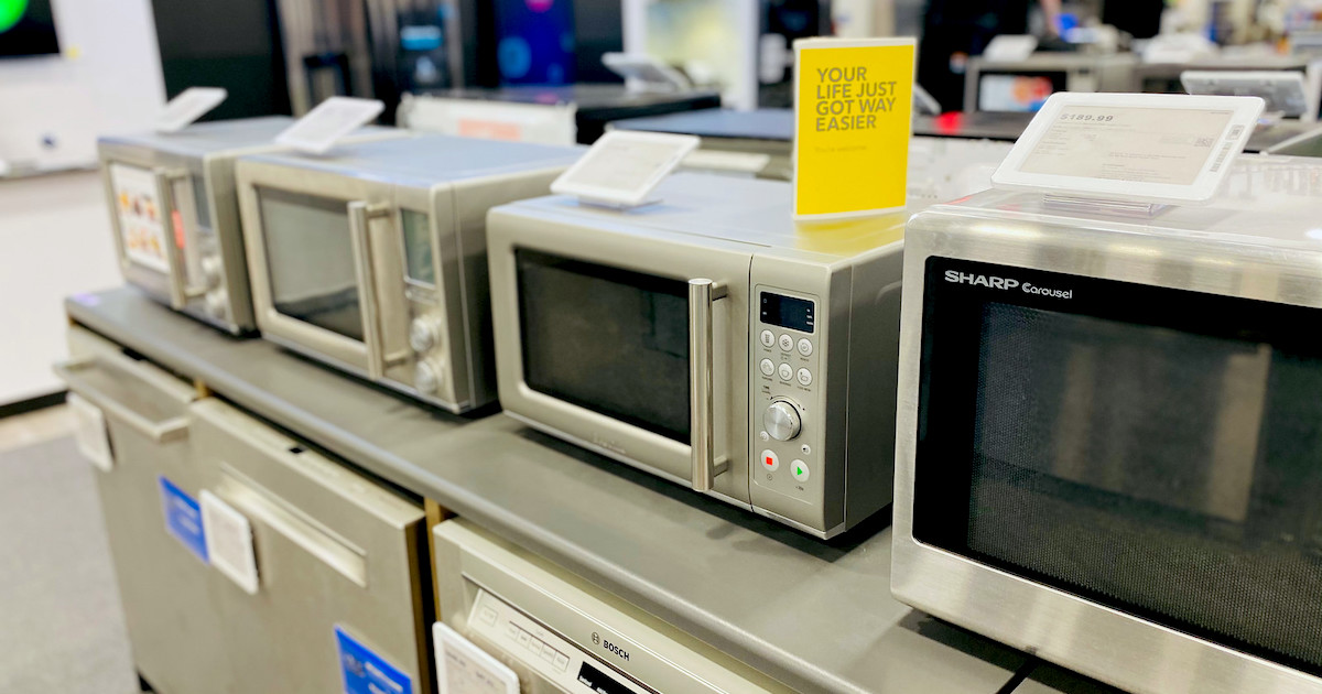 row of stainless steel microwaves on store display