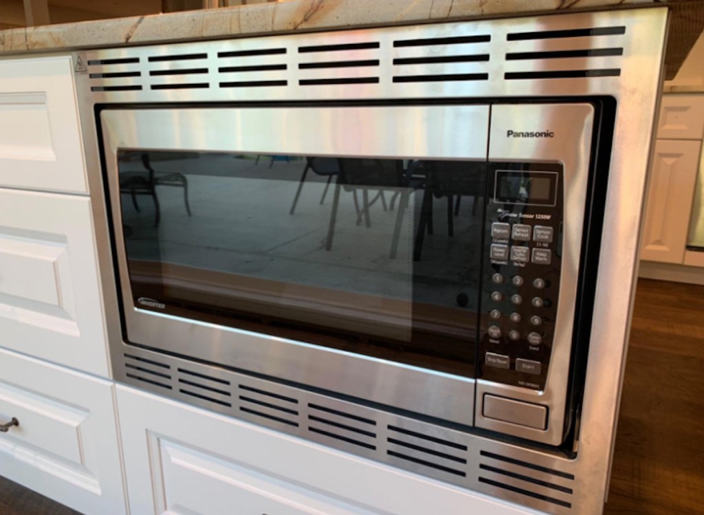 stainless steel microwave oven built into cabinets