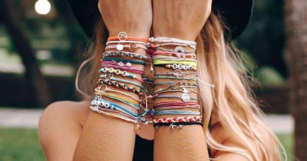 woman wearing lots of pura vida bracelets