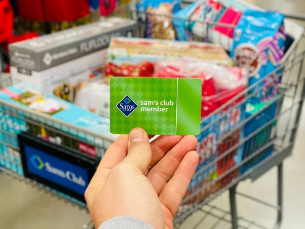 holding a Sam's Club membership card