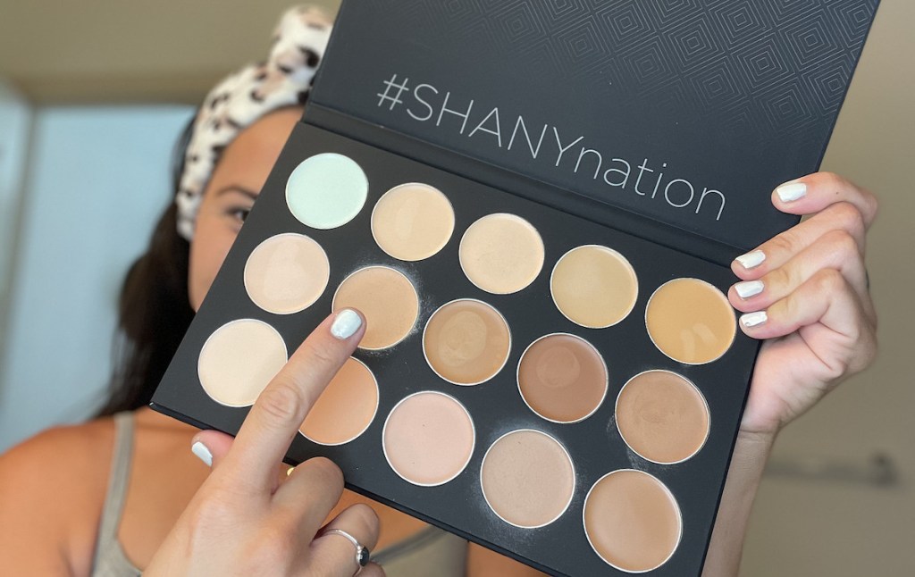 woman holding up neutral makeup palette