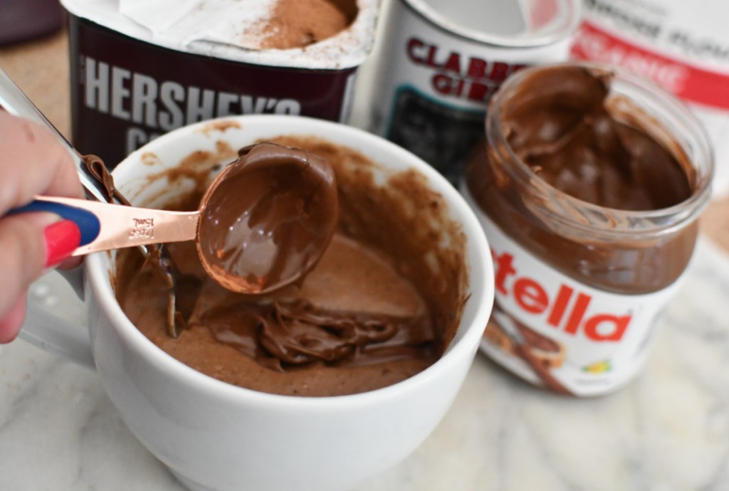 Adding Nutella hazelnut spread to mug cake mix