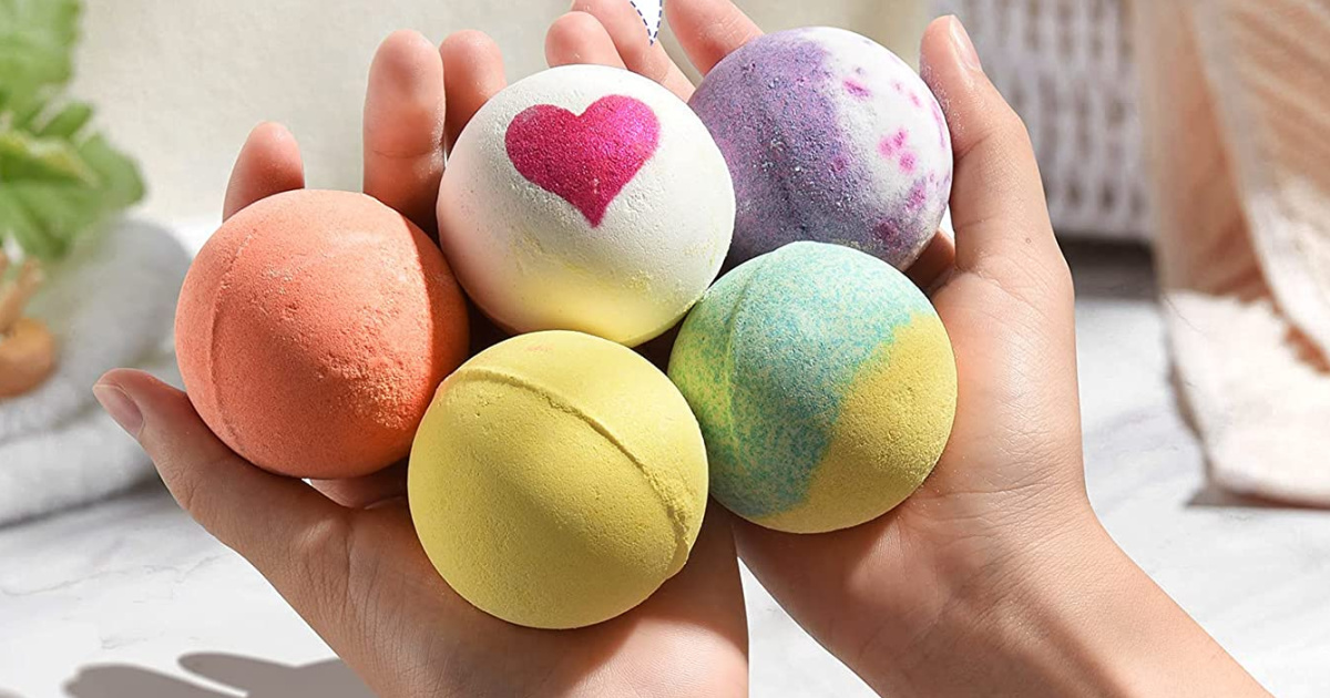 hands holding a variety of bath bombs