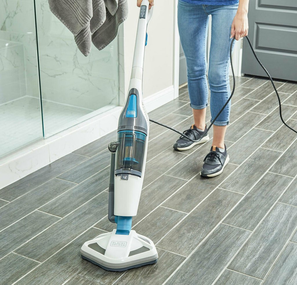 woman using steam mop in bathroom