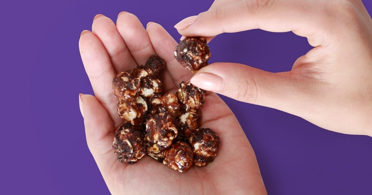 woman's hand holding Crunch 'n Munch Brownie Crunch