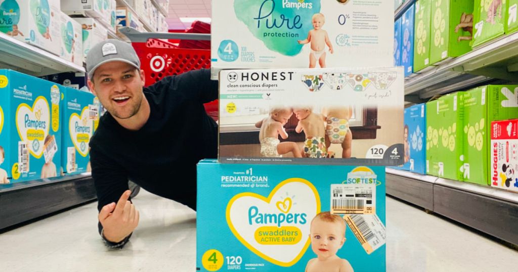 man on floor besides diapers boxes