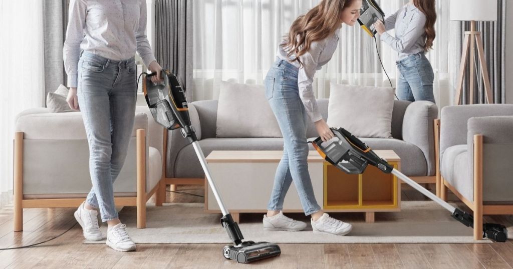 three women vacuuming