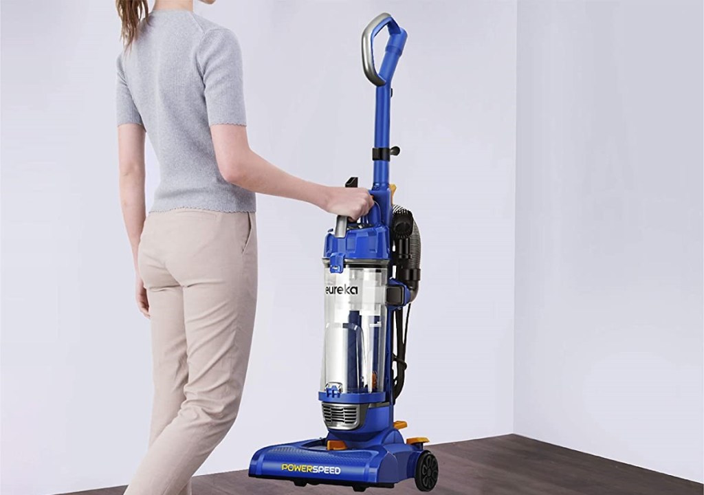 woman carrying a vacuum