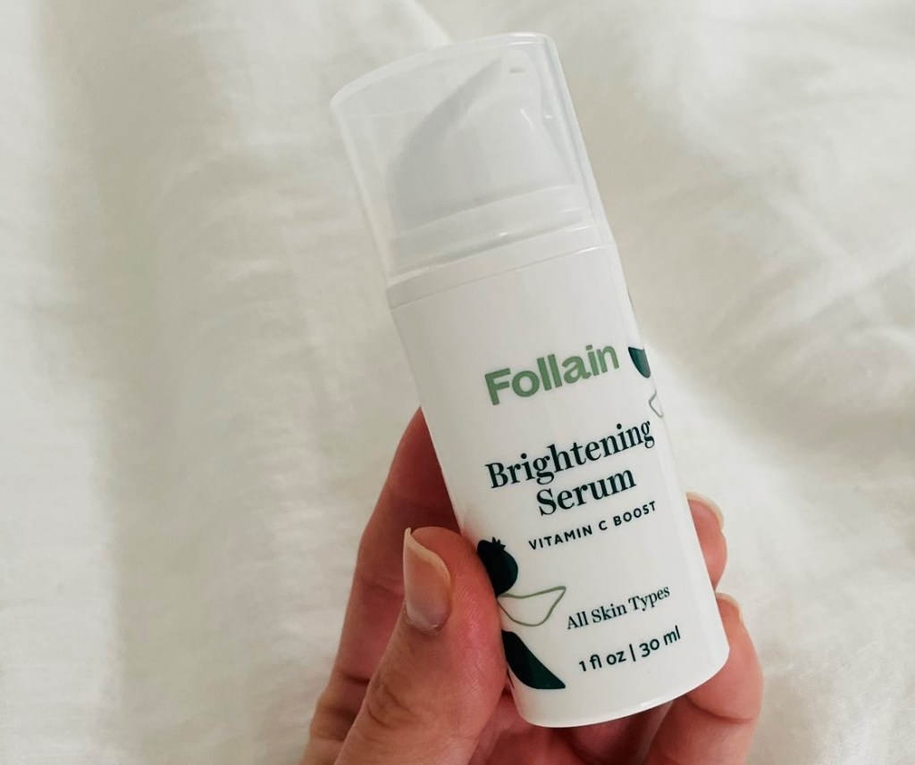 hand holding a bottle of Follain Brightening Serum