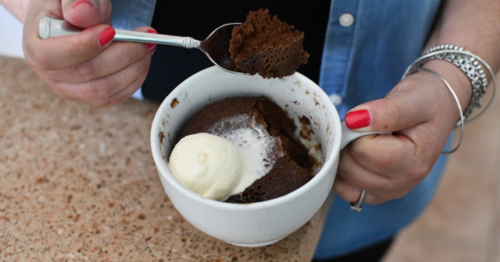 woman holding a Nutella mug cake