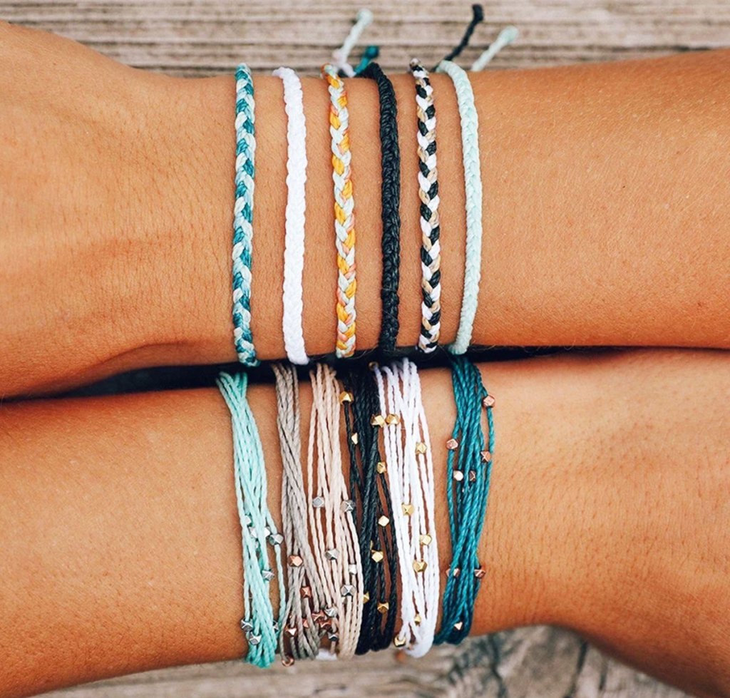 pura vida bracelets on arms