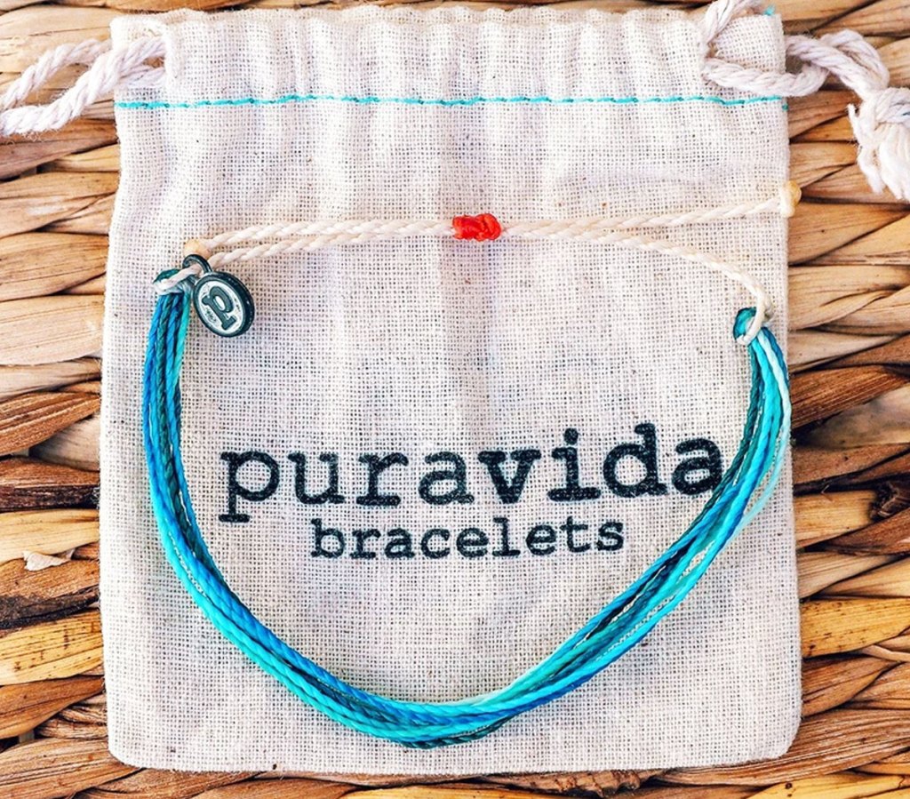 blue bracelet on pura vida bag